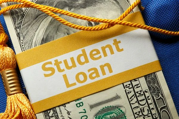 A close-up image shows a rolled-up 100-dollar bill with a "Student Loan" label and a yellow graduation tassel.
