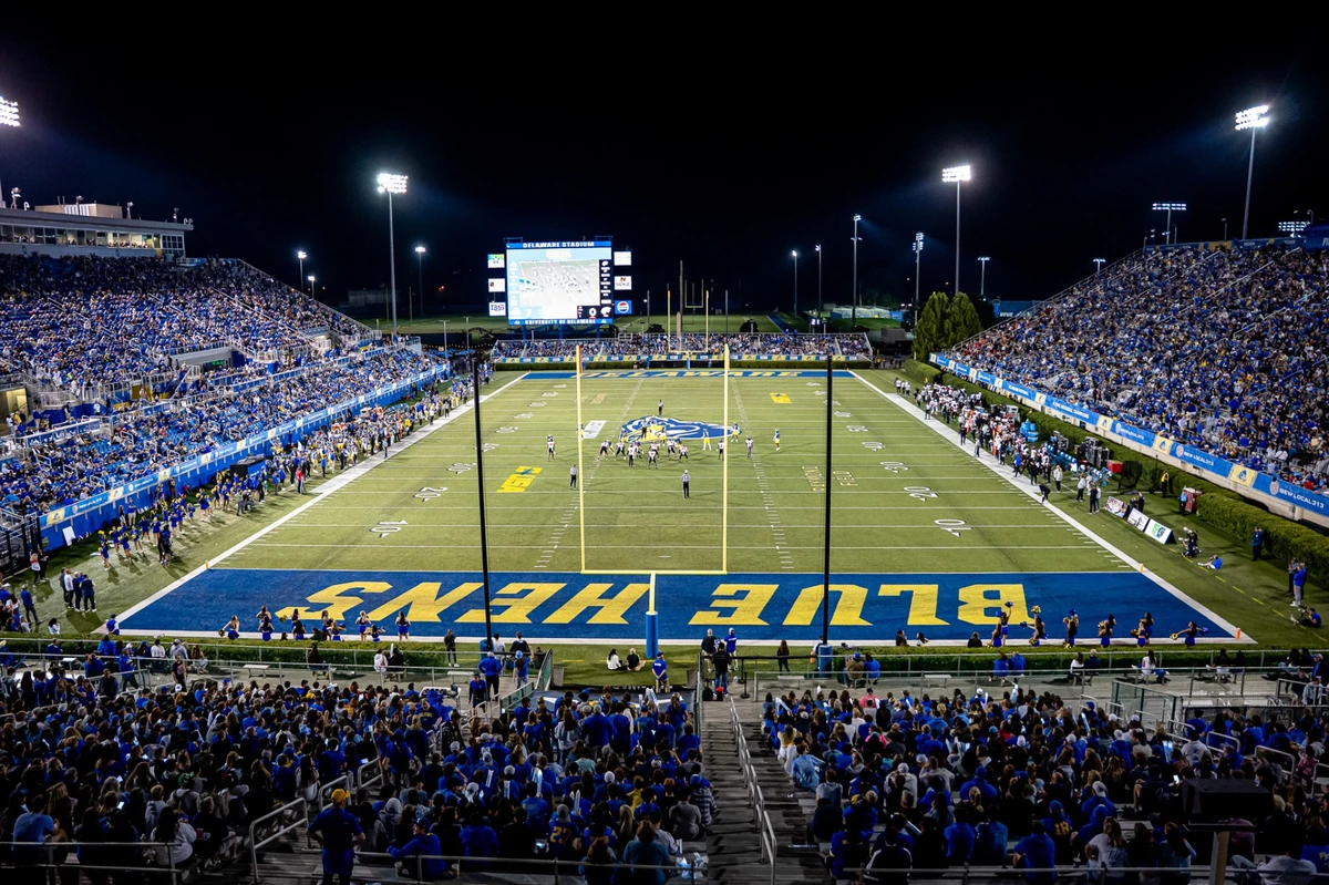 Full stadium of fans watching a football game.